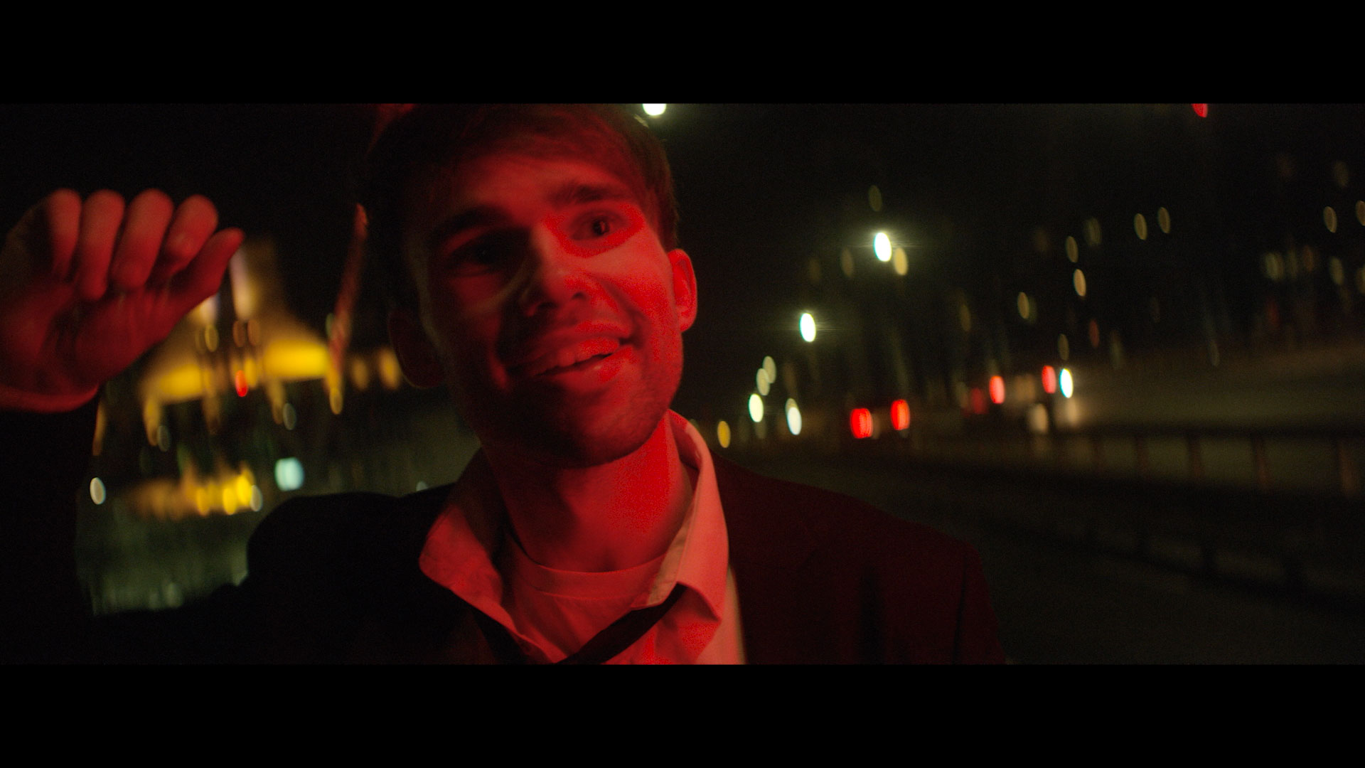 Clockworks - Video Still - Lead singer walking looking bemused along street at night 
